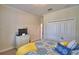 Bright bedroom with patterned bedding, closet space, and soft carpet at 1433 Bunker Dr, Davenport, FL 33896