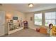 View of bedroom with a pair of windows providing natural light and a bookshelf at 1433 Bunker Dr, Davenport, FL 33896