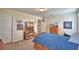 This is a bedroom with a wood bed frame, carpet, a window and a bookshelf with awards at 1433 Bunker Dr, Davenport, FL 33896