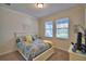 Comfortable bedroom with patterned bedding, natural light and accent decor at 1433 Bunker Dr, Davenport, FL 33896