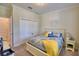 Cozy bedroom with yellow and blue accents, natural light and closet at 1433 Bunker Dr, Davenport, FL 33896