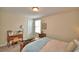 Bright bedroom featuring neutral walls, a desk and a comfortable bed with patterned pillows at 1433 Bunker Dr, Davenport, FL 33896