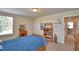 This is a bedrooom with a wood bed frame, carpet, a window and access to the hallway at 1433 Bunker Dr, Davenport, FL 33896