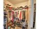 Walk-in closet filled with many shelves and hanging rods with clothes and shoes at 1433 Bunker Dr, Davenport, FL 33896