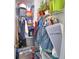 Walk-in closet filled with many shelves and hanging rods with clothes and items at 1433 Bunker Dr, Davenport, FL 33896