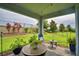 Charming covered patio featuring comfortable seating, potted plants, and views of the landscaped backyard at 1433 Bunker Dr, Davenport, FL 33896