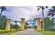 ChampionsGate community entrance welcomes visitors with lush landscaping and stately columns at 1433 Bunker Dr, Davenport, FL 33896