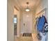 Welcoming entryway with tile floors, a coat rack with bench, and a front door with sidelights for natural light at 1433 Bunker Dr, Davenport, FL 33896