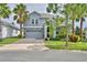Charming two-story home boasts a paved driveway, a two-car garage, and well-maintained landscaping at 1433 Bunker Dr, Davenport, FL 33896