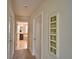 Hallway leading to the bathroom showing the bathtub and a decorative frame on the wall at 1433 Bunker Dr, Davenport, FL 33896