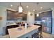 Modern kitchen island with stainless steel appliances and dark wood cabinets at 1433 Bunker Dr, Davenport, FL 33896