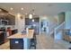 Bright kitchen features a central island, stainless appliances, and access to the staircase at 1433 Bunker Dr, Davenport, FL 33896