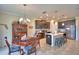 Open kitchen with stainless appliances, dark wood cabinets, large island and adjacent dining area at 1433 Bunker Dr, Davenport, FL 33896