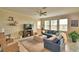 Relaxing living room boasts a plush blue sectional, neutral ottoman and light tile flooring for a comfortable atmosphere at 1433 Bunker Dr, Davenport, FL 33896