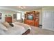 Spacious carpeted main bedroom with windows, entertainment center, and a bed at 1433 Bunker Dr, Davenport, FL 33896