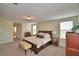 Spacious carpeted main bedroom with windows, a bed, and furniture at 1433 Bunker Dr, Davenport, FL 33896
