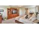 Spacious carpeted main bedroom with wooden entertainment center and a bed at 1433 Bunker Dr, Davenport, FL 33896