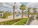 Community pool and splash pad with lush palms and landscaping, perfect for Gathering fun and relaxation at 1433 Bunker Dr, Davenport, FL 33896