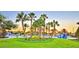 A community splash pad and pool surrounded by palm trees and green lawns against a sunny sky at 1433 Bunker Dr, Davenport, FL 33896