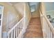 Carpeted staircase with white banister leads to upper level at 1433 Bunker Dr, Davenport, FL 33896
