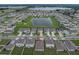 An aerial view of a home with access to a community pond and lush landscaping at 1719 Durden Dr, Winter Haven, FL 33880