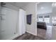Bathroom features a shower with curtain and an open doorway to the carpeted bedroom at 1719 Durden Dr, Winter Haven, FL 33880