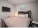 Comfortable bedroom featuring a bed, mounted TV, and tasteful decor, perfect for relaxing and unwinding in style at 1719 Durden Dr, Winter Haven, FL 33880