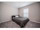Minimalist bedroom featuring neutral walls, a single bed, and soft carpet, creating a simple and relaxing atmosphere at 1719 Durden Dr, Winter Haven, FL 33880