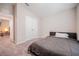 Neutral bedroom featuring carpet, closet, bed and view to living space at 1719 Durden Dr, Winter Haven, FL 33880