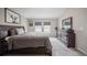 Bedroom with a large bed, dresser, and two windows at 1719 Durden Dr, Winter Haven, FL 33880