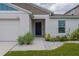 Close-up of the front entrance showcasing a modern door, stylish landscaping, and a well-maintained facade at 1719 Durden Dr, Winter Haven, FL 33880