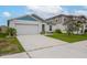 Well-maintained single-story home with a two-car garage and manicured front yard, perfect for a Gathering or individual at 1719 Durden Dr, Winter Haven, FL 33880
