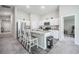 Kitchen boasts a center island with granite counters, stainless appliances, and a breakfast bar at 1719 Durden Dr, Winter Haven, FL 33880