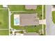 Aerial shot of the property featuring a private swimming pool, well-maintained lawn, and fenced yard at 1765 Kingsmill Dr, Bartow, FL 33830