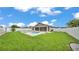 Beautiful backyard showcasing a swimming pool, patio area, and lush green lawn at 1765 Kingsmill Dr, Bartow, FL 33830