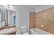 Bathroom with tile surround bathtub, toilet, and vanity with sink and wall mirror at 1765 Kingsmill Dr, Bartow, FL 33830