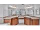 Spacious bathroom featuring dual sinks, wood cabinetry, and a large mirror at 1765 Kingsmill Dr, Bartow, FL 33830