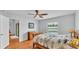 Charming bedroom with wood floors, a patterned quilt, and natural light from the window at 1765 Kingsmill Dr, Bartow, FL 33830