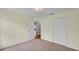 Bedroom with plush carpet, cream walls and access to another room with hardwood flooring at 1765 Kingsmill Dr, Bartow, FL 33830