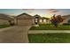 Charming single-story home with a well-manicured lawn, stone accents, and a two-car garage at 1765 Kingsmill Dr, Bartow, FL 33830