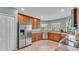 Bright kitchen with stainless steel refrigerator and ample cabinet space at 1765 Kingsmill Dr, Bartow, FL 33830