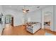 Comfortable living room with archways, wood floors, ceiling fan, and access to other rooms at 1765 Kingsmill Dr, Bartow, FL 33830
