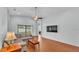 Open concept living room with wood floors, light blue walls, ceiling fan, and sliding glass door at 1765 Kingsmill Dr, Bartow, FL 33830