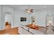 Spacious living room features wood floors, archways, light blue walls, and ceiling fan at 1765 Kingsmill Dr, Bartow, FL 33830