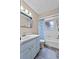 This bathroom features blue vanity, a shower with blue curtain and a toilet at 1810 Roanoke Ave, Lakeland, FL 33803