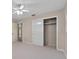 Bright bedroom featuring a ceiling fan, neutral carpet, a closet, and light-colored walls at 1810 Roanoke Ave, Lakeland, FL 33803