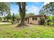 A cozy home with lush greenery and manicured landscaping in front yard at 1810 Roanoke Ave, Lakeland, FL 33803