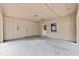 Spacious garage area with concrete flooring, door, and exterior window at 1810 Roanoke Ave, Lakeland, FL 33803