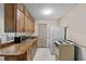 Functional kitchen with wooden cabinets, tile floors, and standard appliances at 1810 Roanoke Ave, Lakeland, FL 33803
