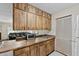 Kitchen bar with wooden cabinets with view to kitchen and living room with dark sofa at 1810 Roanoke Ave, Lakeland, FL 33803